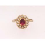 An 18ct ruby cluster ring stamped 'EJ Co', finger size L.