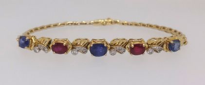 A 18ct yellow gold ruby, sapphire and diamond set bracelet.