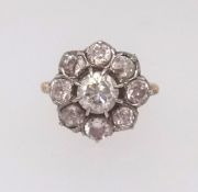 An antique diamond cluster ring set with an arrangement of nine old cut diamonds, finger size P.