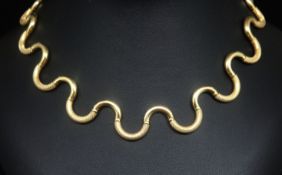 A stylish 18ct gold necklace of curve design with engine turned matt and gloss finish, marked 750,