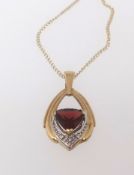 A 9ct modern garnet and diamond drop pendant necklace.