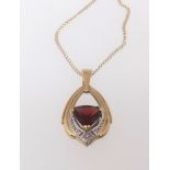 A 9ct modern garnet and diamond drop pendant necklace.