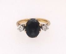 An 18ct sapphire and diamond three stone ring, finger size J.