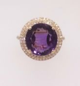 A 14ct diamond and amethyst cluster ring the centre stone approx. 6.47ct diamonds approx. 0.50ct