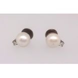 A pair of cultured pearl earrings.