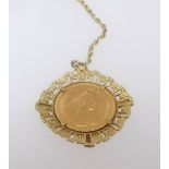 A QEII gold sovereign set within a pendant necklace.