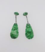 A pair of jade pendant earrings.