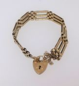 A 9ct gold gate bracelet with padlock, length 190mm, width 11.3mm, 21.30gms.