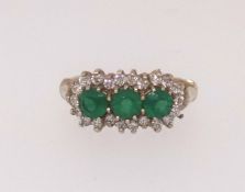 A 9ct emerald style diamond cluster ring, finger size K.