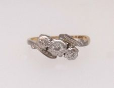 An 18ct antique diamond three stone ring, finger size K.