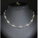 A 9ct yellow and white gold necklace set with oval and curved sections (approx. 14.5gms) new in 2009
