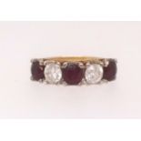 An 18ct ruby and diamond half eternity ring, set with five stones, finger size L (purchased at