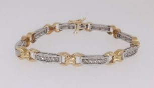 A modern 18ct white and yellow gold bracelet, channel set with gem stones approx. 18.8gms.