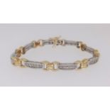 A modern 18ct white and yellow gold bracelet, channel set with gem stones approx. 18.8gms.