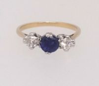 An 18ct sapphire and diamond three stone, finger size K.