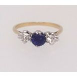 An 18ct sapphire and diamond three stone, finger size K.