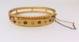 A 9ct diamond and ruby set bangle approx. 13.9gms.