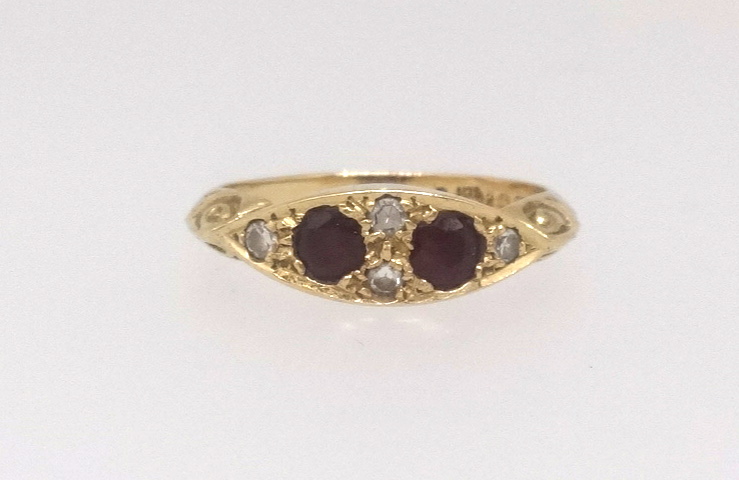 An 18ct ruby and diamond dress ring, finger size N.