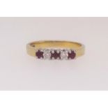 A 18ct ruby and diamond five stone ring, finger size P.