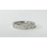 A platinum diamond set wedding band