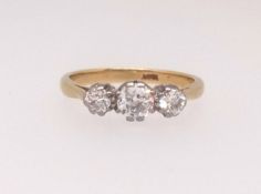 An 18ct diamond three stone ring, finger size N.