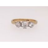 An 18ct diamond three stone ring, finger size N.