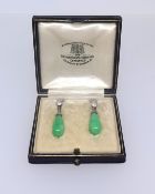 A pair of jade and diamond earrings. Goldsmiths and Silversmiths, London.