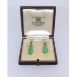 A pair of jade and diamond earrings. Goldsmiths and Silversmiths, London.