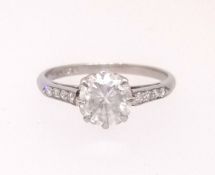 A platinum diamond solitaire ring, approx 1.02ct set with eight further diamonds to the shoulders,