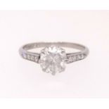 A platinum diamond solitaire ring, approx 1.02ct set with eight further diamonds to the shoulders,