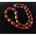 A red amber bead necklace, approx 108gms.