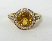 A citrine and diamond ring, finger size O.