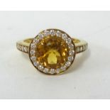 A citrine and diamond ring, finger size O.