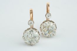 A beautiful pair of period cushion shaped old cut 2.50ct diamond ear studs with hook/wire fitting,