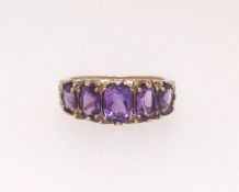 A 9ct amethyst five stone ring, finger size O.