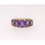 A 9ct amethyst five stone ring, finger size O.