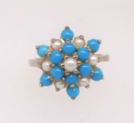 A 9ct turquoise and pearl cluster ring, finger size P.