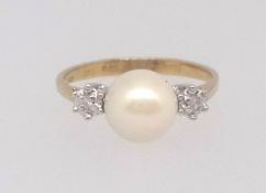 An 18ct pearl and diamond three stone ring, finger size N.
