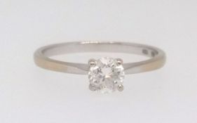 An 18ct white gold diamond solitaire ring, stamped 750 set with a round brilliant cut white