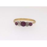 A ruby and diamond dress ring set in yellow gold unmarked, finger size P.