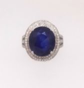 A 14ct white gold and diamond ring set with an oval cut blue gem stone approx. 6.5ct diamond