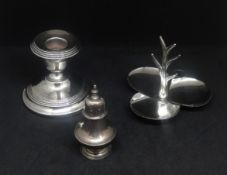 A modern silver ring stand, short silver candlestick, height 7cm and a silver pepper pot.