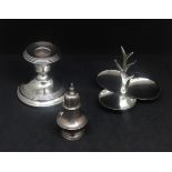 A modern silver ring stand, short silver candlestick, height 7cm and a silver pepper pot.