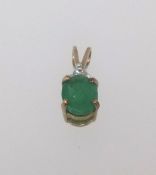 A 9ct modern diamond and emerald drop pendant.