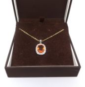 An 18ct diamond and citrine pendant and chain.