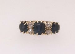 An 18ct sapphire and diamond seven stone ring, finger size K.