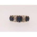 An 18ct sapphire and diamond seven stone ring, finger size K.