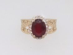 A 14K yellow gold and diamond ring, set with an oval cut ruby approx. 3.10ct diamond approx. 0.30ct,