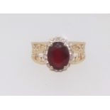 A 14K yellow gold and diamond ring, set with an oval cut ruby approx. 3.10ct diamond approx. 0.30ct,