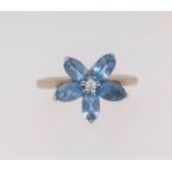 A 9ct topaz and diamond set flower ring, finger size K.